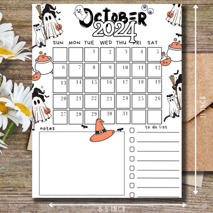 October 2024 calendar page with charming black and white Halloween ghost illustrations and orange accents, 11 x 8.5 inch size, displayed on wooden surface with daisy flowers, ideal for students and classroom planning.