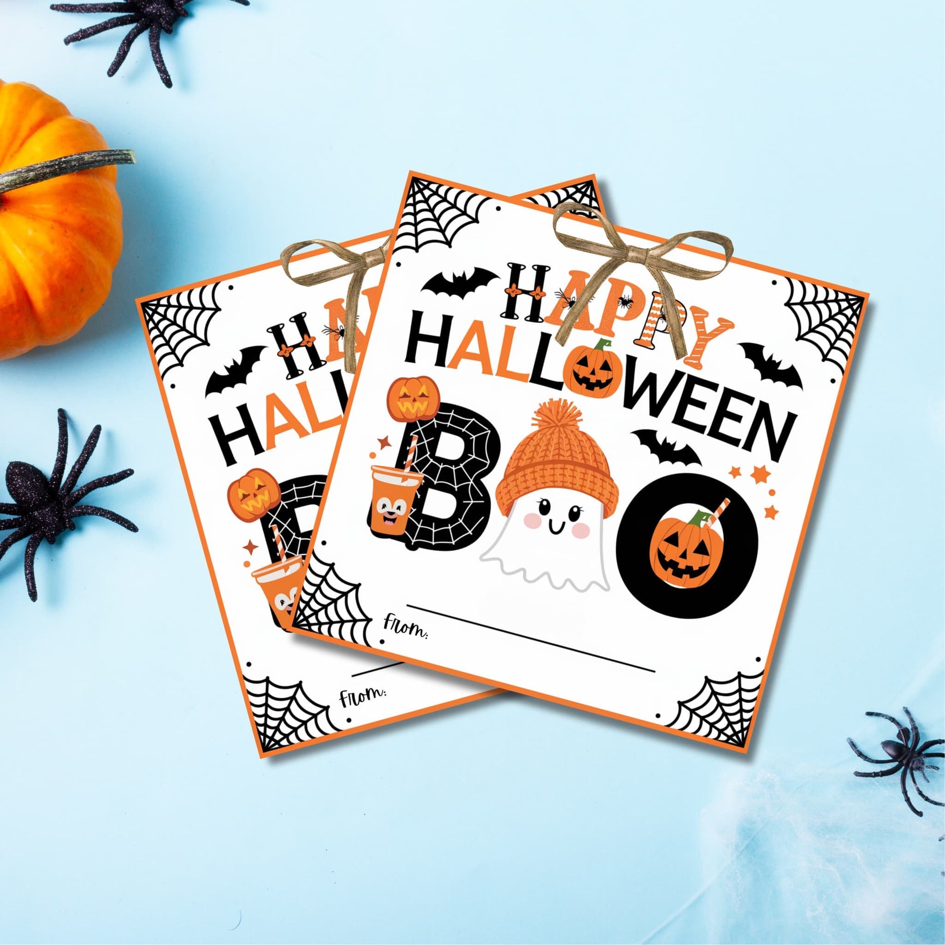 Two Halloween favor tags with "Happy Halloween" text, spider webs, and cute ghost design on light blue background with pumpkin decorations