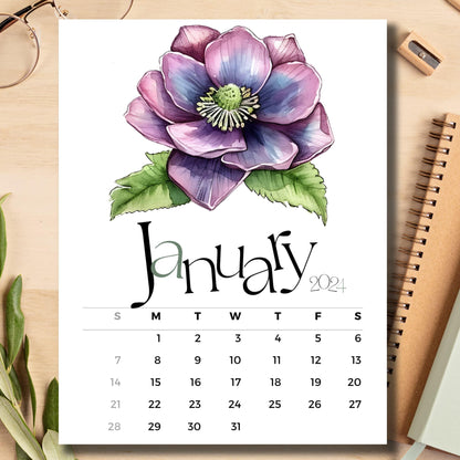 January 2024 Hellebores floral calendar on light brown wooden desk with school supplies like notebook and pencil.