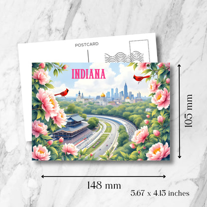 Indiana souvenir postcard with dimensions displayed: 148mm x 105mm (5.67 x 4.13 inches). Features Indy 500 racetrack, Indianapolis skyline, pink peonies frame, and standard postcard back layout.