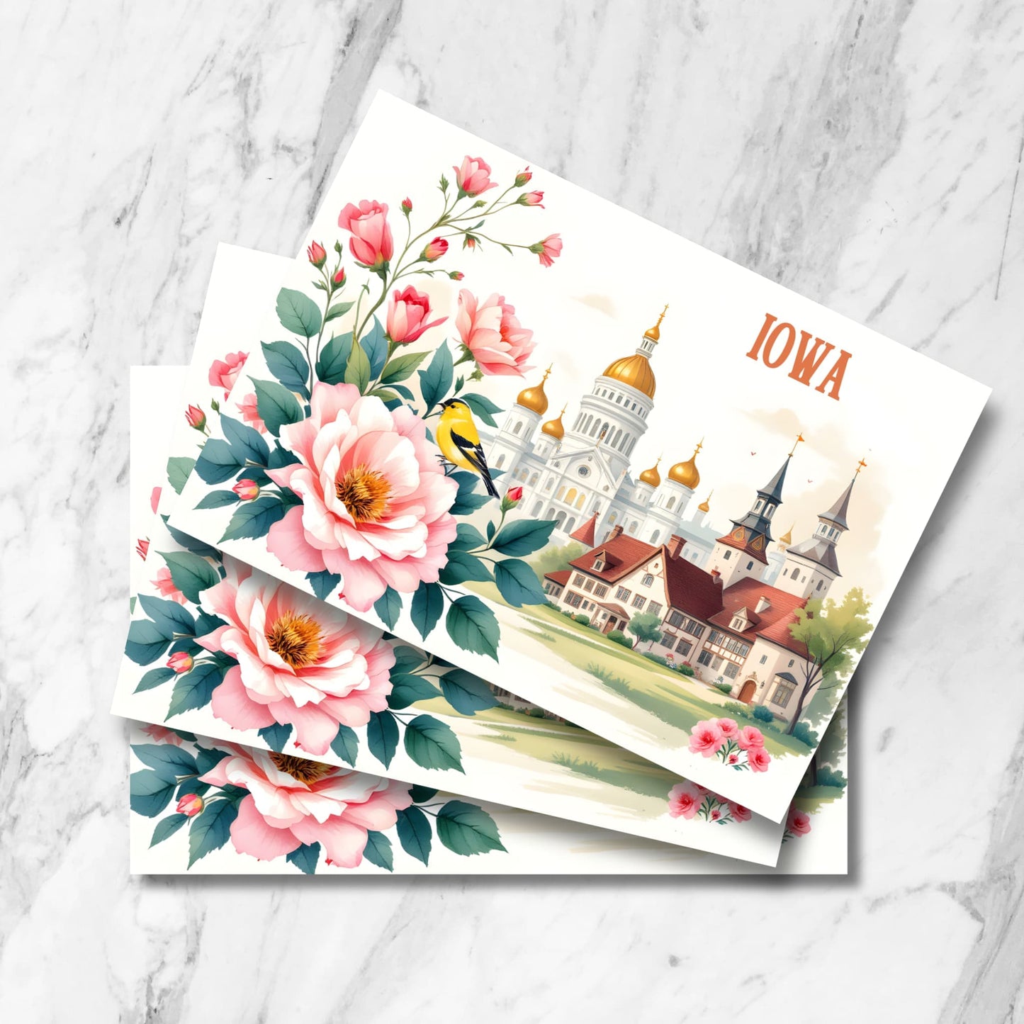 Vintage-style Iowa postcard featuring state capitol with golden domes, traditional architecture, and state bird goldfinch amid pink wild roses. Watercolor illustration with European-inspired buildings and detailed floral border.