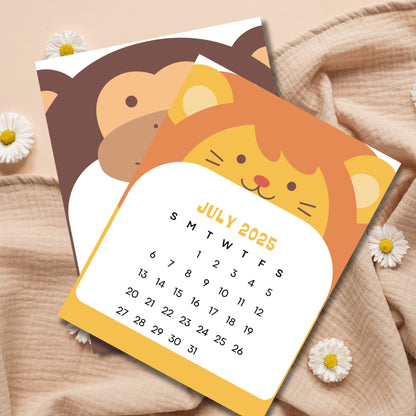 July 2025 animal calendar with orange cat design and brown monkey peeking behind. Sunday-start layout with daisy flower decorations on beige fabric.