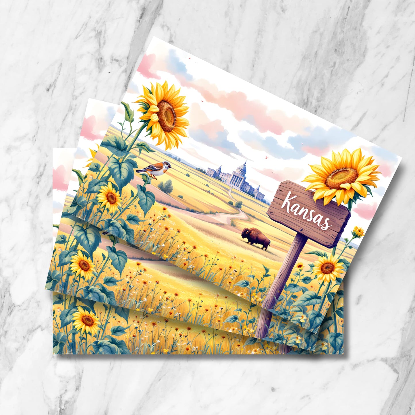 Rustic Kansas postcard featuring wooden signpost among sunflowers, with state capitol in distance. Prairie landscape includes grazing buffalo and meadowlark perched on sunflower against pink-tinged clouds.