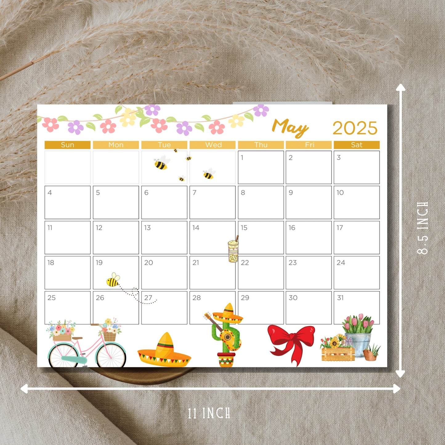 May 2025 calendar page measuring 11x8.5 inches with spring flower border, bees, bicycle, and Cinco de Mayo decorations on natural background