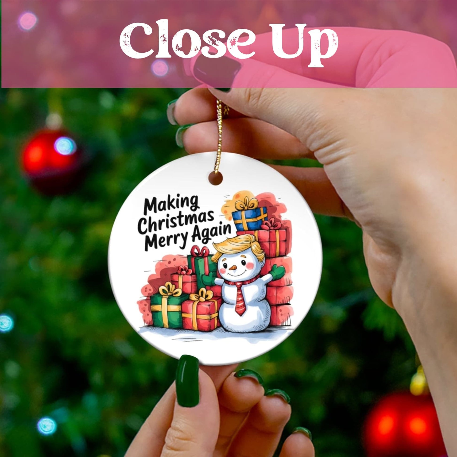 Close-up view of holiday ceramic ornament showing cheerful snowman character with red tie next to stack of wrapped gifts, against blurred Christmas tree background.