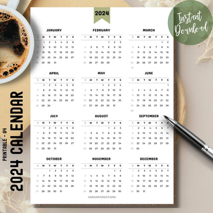  Minimalist 2024 full year calendar printed page on brown desk with coffee cup on left and pen on right.