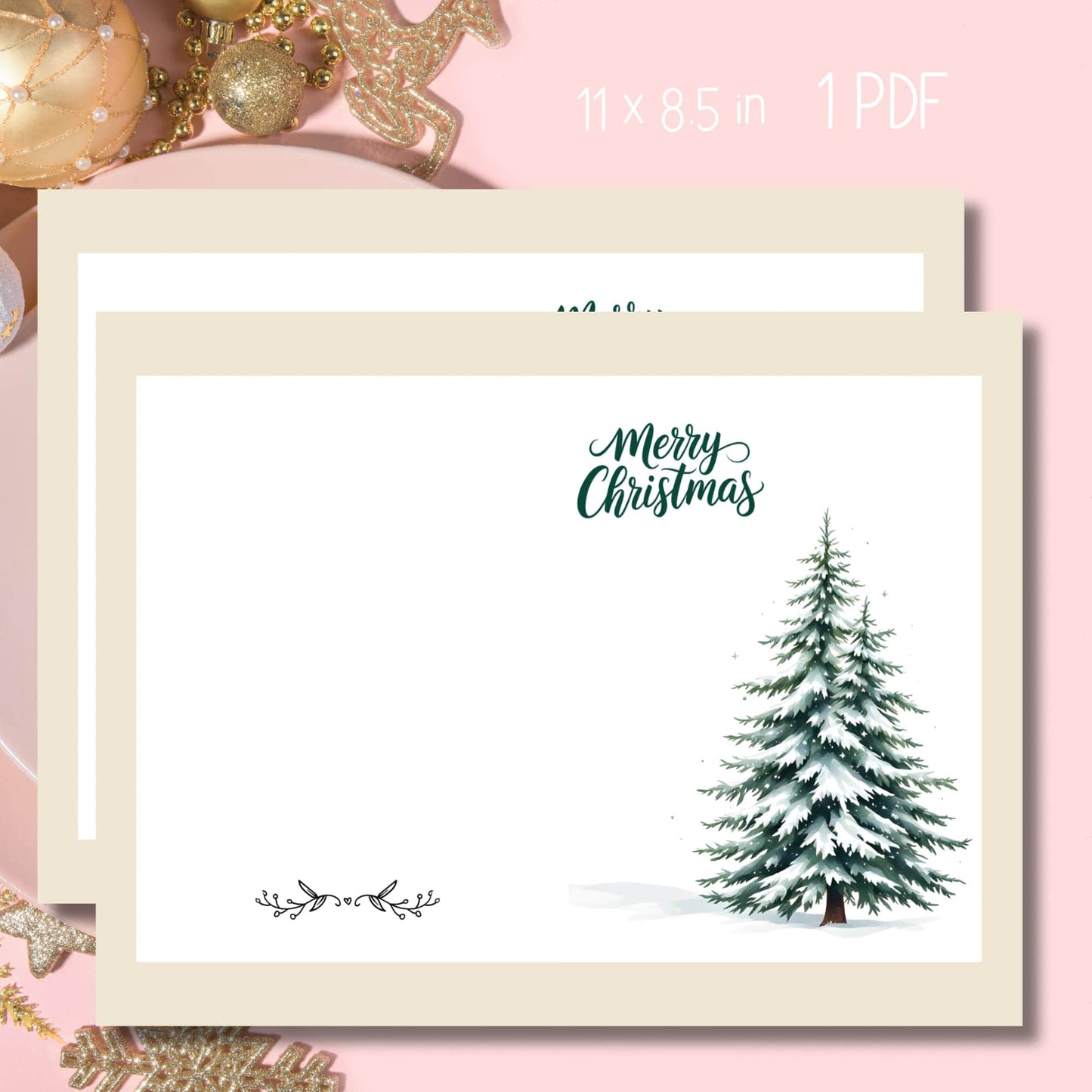 Free printable Christmas card featuring watercolor snowy pine tree, green calligraphy 'Merry Christmas' text, and delicate black botanical divider, shown with gold ornaments on pink background, 11x8.5 format