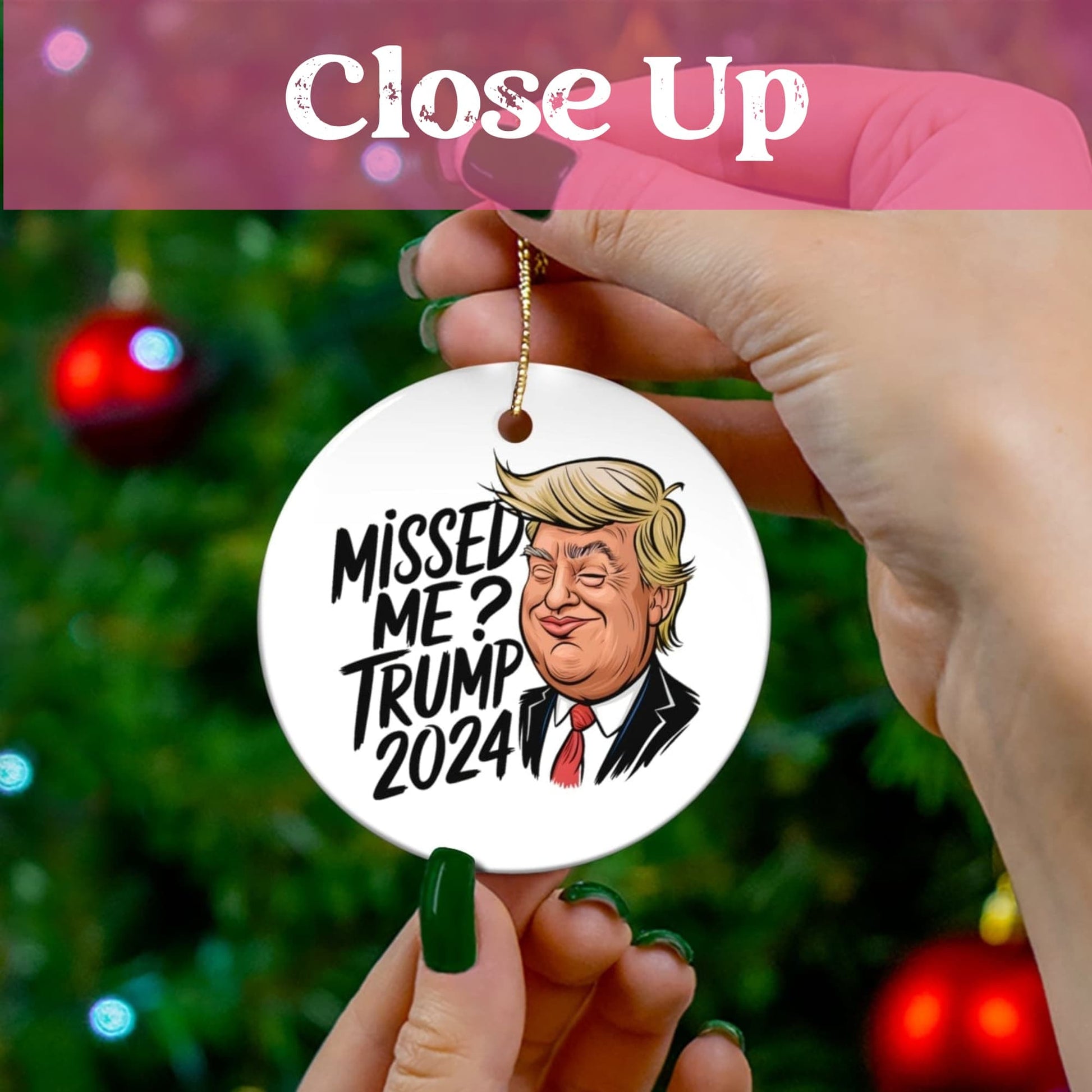 Close-up view of humorous political ceramic ornament held against festive Christmas tree background with soft bokeh lighting effects.