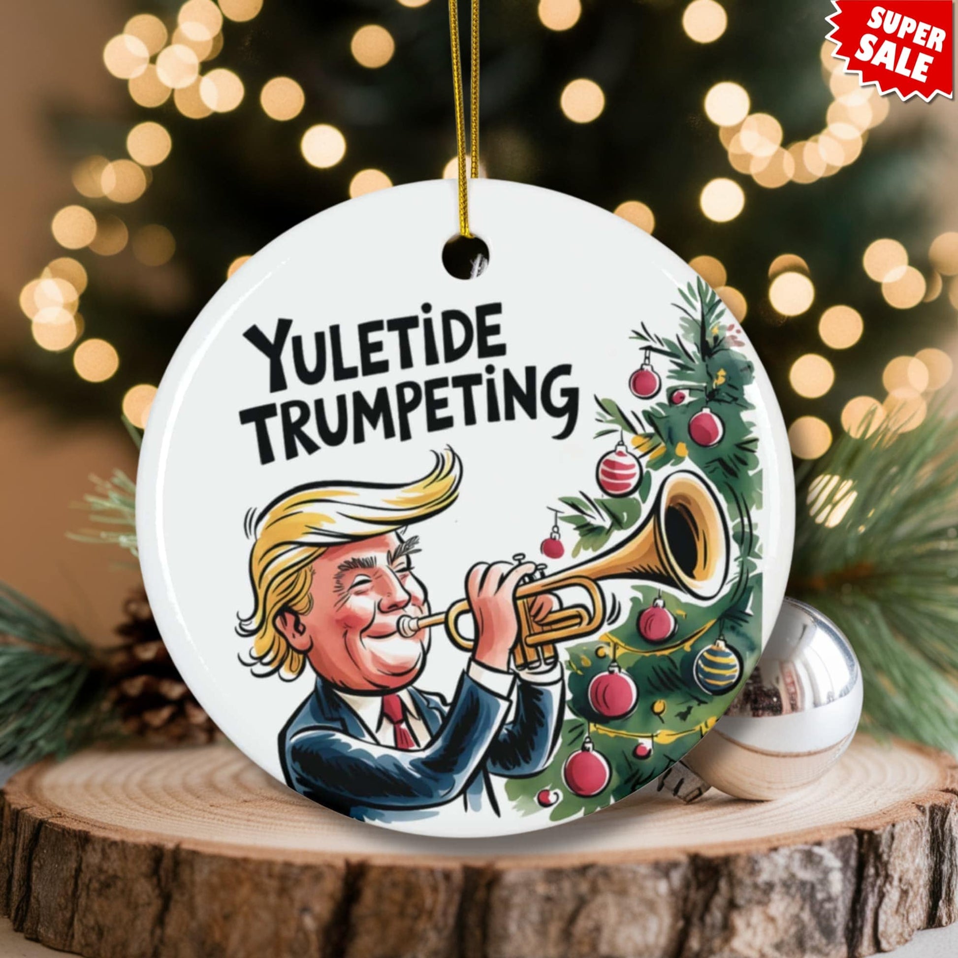 Festive ceramic ornament featuring trumpet player and Christmas tree artwork, displayed on wood slice with pinecones and warm bokeh lighting, Super Sale offer.