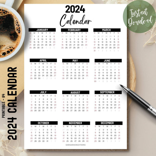 2024 full year office calendar on brown desk with coffee cup on left and pen on right side.