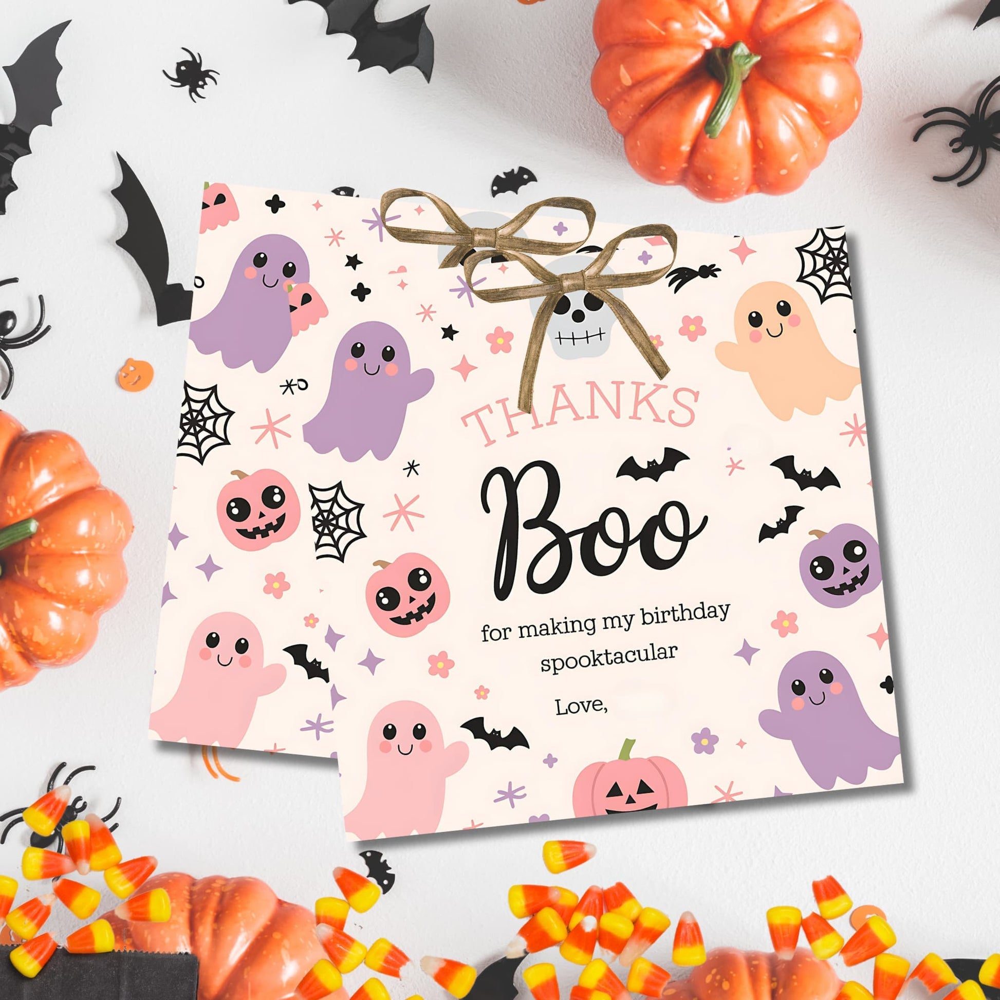 Halloween birthday thank you tags with adorable ghosts and pumpkins, displayed with festive decorations and candy corn