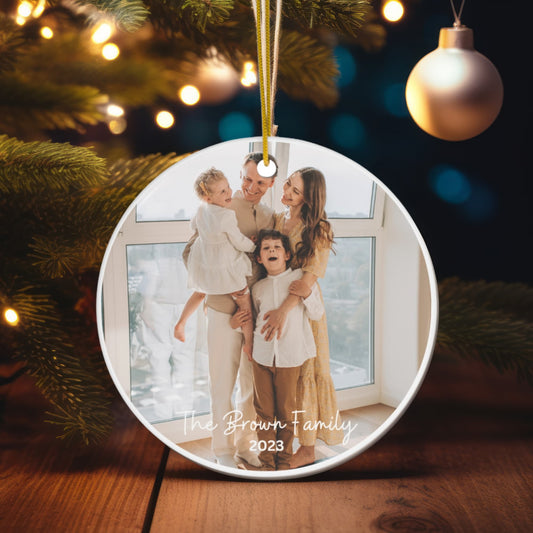  Close-up of a Custom Christmas Ornament with a photo, hanging on a tree, showcasing its festive elegance.