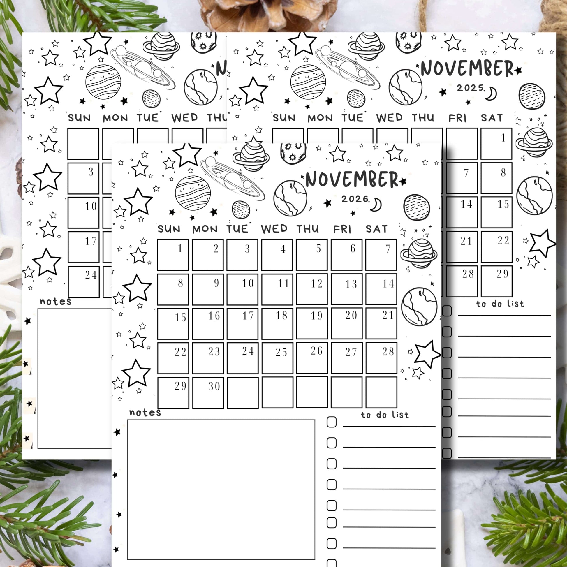 Three-year November calendar with hand-drawn planets, stars and doodles, featuring notes and to-do list sections, styled with pine branches