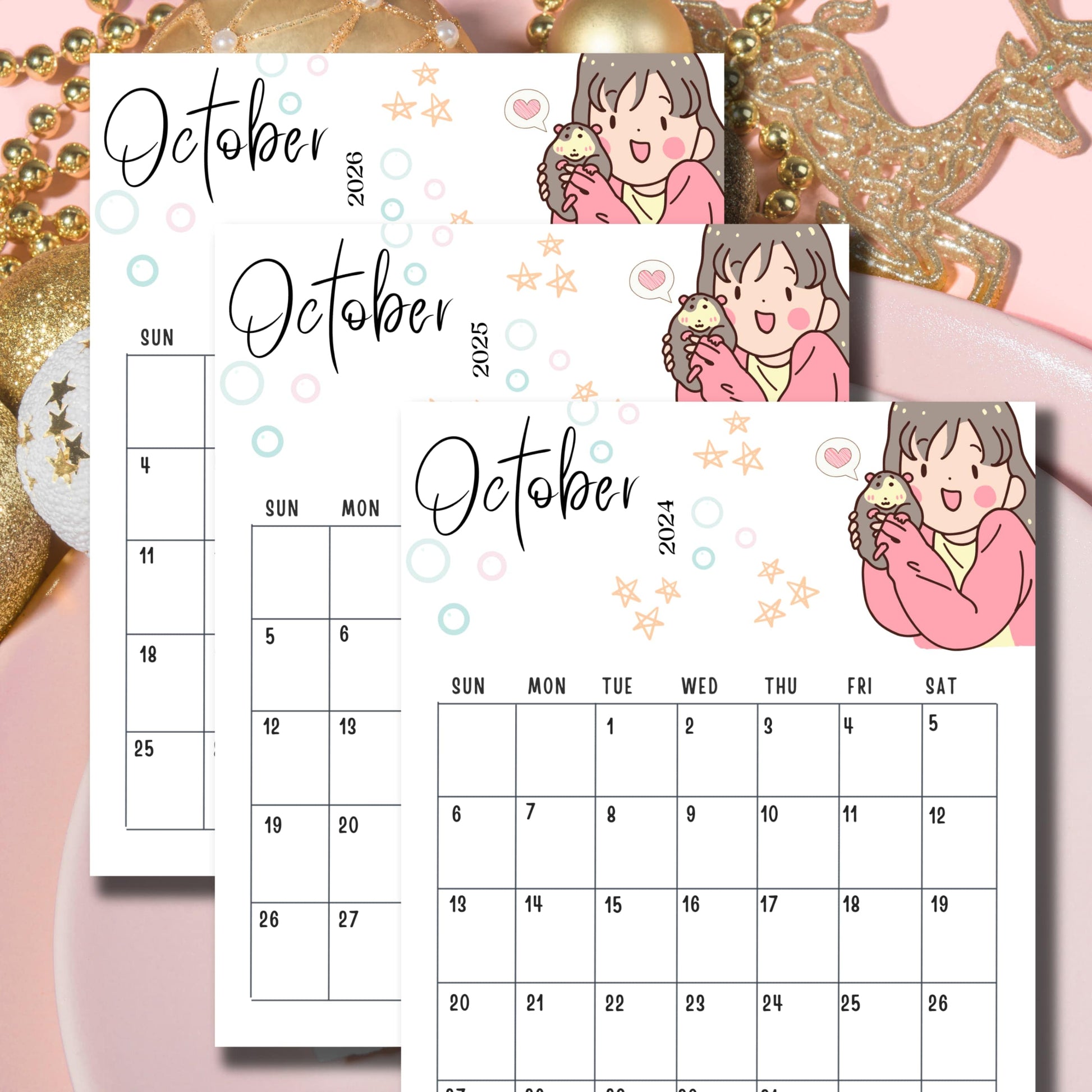 Flatlay of October 2024-2026 kawaii calendars with chibi girl and hedgehog design, arranged on pink background with gold holiday decorations.