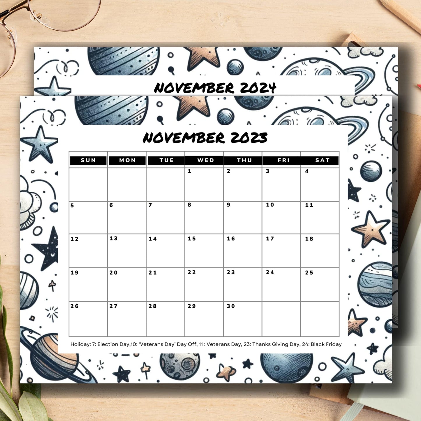 Planets & Stars themed November 2023 & 2024 calendar alongside notebooks for planning.