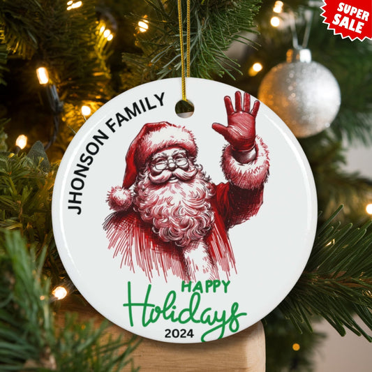 Santa family ornament hanging on lit Christmas tree with white baubles and pine needles, showing Super Sale offer.