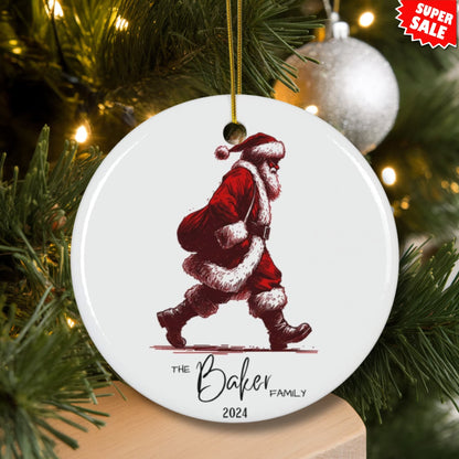 Baker family ornament with walking Santa design displayed on lit Christmas tree with silver ornaments and Super Sale tag.