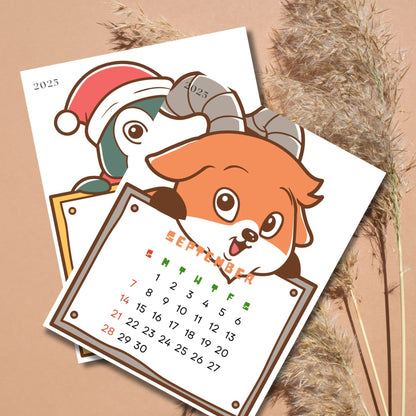 September 2025 calendar page with cartoon fox and penguin characters. Fox holds calendar grid with weekdays highlighted in green and red, displayed against natural pampas grass background.