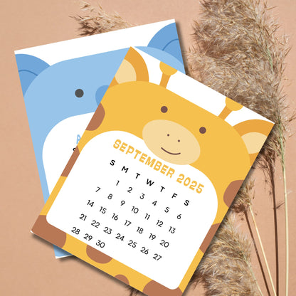 September 2025 calendar featuring smiling giraffe design with elephant peeking behind. Sunday-start grid layout on natural pampas grass background.