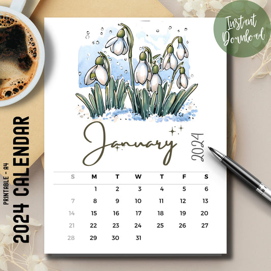 January 2024-25 snowdrops floral calendar with coffee cup and pen on a brown desk.