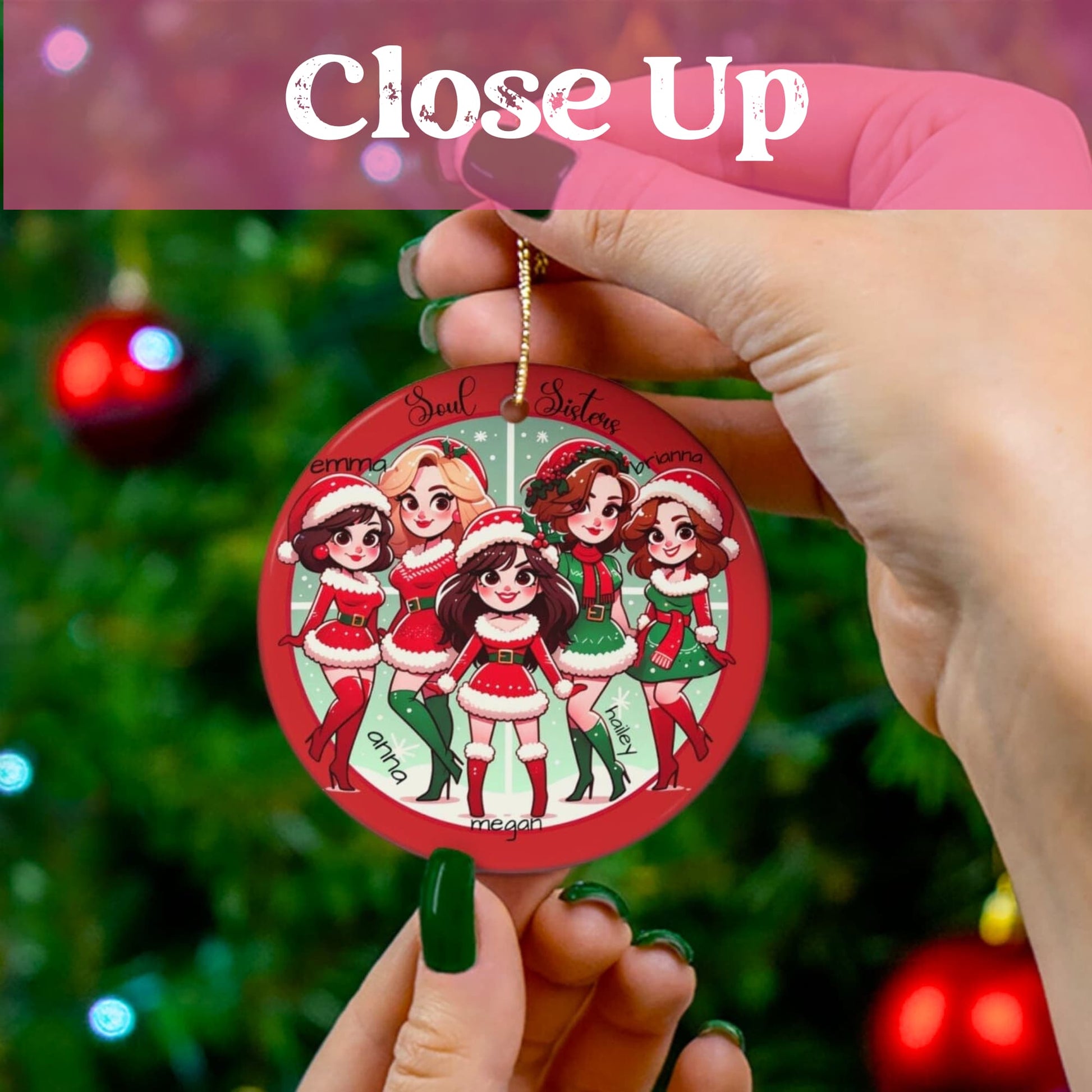 Close-up of hand holding Soul Sisters Christmas ornament with green painted nails, Christmas tree and red ornaments visible in background