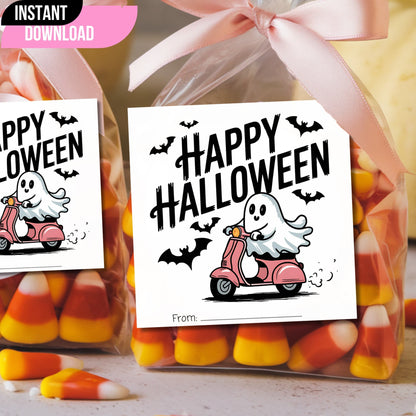Halloween favor tags featuring ghost riding pink scooter, attached to candy bags with pink ribbon for trick-or-treat goodies