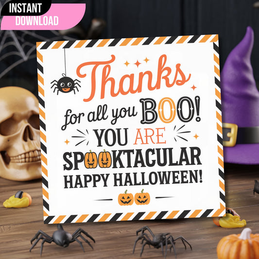 Instant download Halloween thank you tag with orange and black striped border, featuring cute spider and pumpkins, styled with skull and Halloween decor on wooden surface.