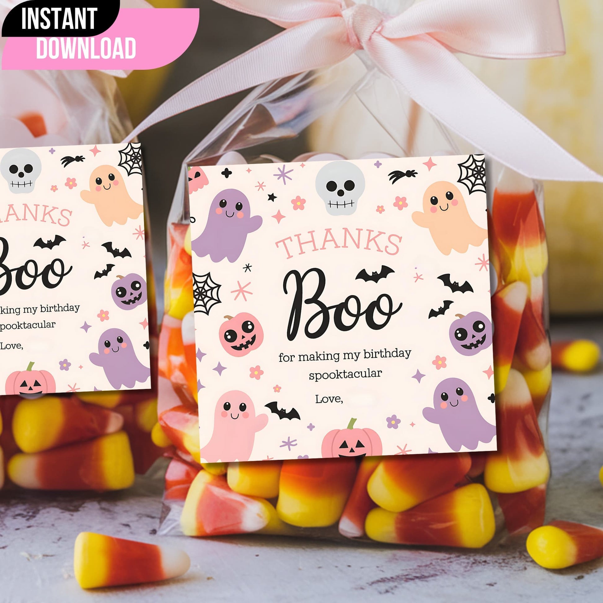 Pink Halloween "Thanks Boo" birthday favor tags attached to candy bags with ribbon, featuring cute ghosts and pumpkins